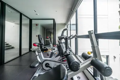 a gym with several exercise bikes in a room at Mountain view apartment in the heart of BangTao in Bang Tao Beach