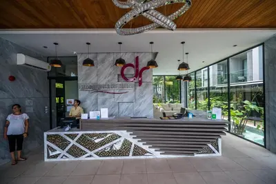 a woman standing in the lobby of a building at Mountain view apartment in the heart of BangTao in Bang Tao Beach