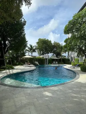 a large swimming pool with people in it at Title V Poolside Pool View Gym Hammam in Rawai Beach