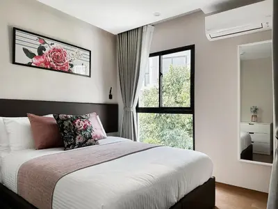 a bedroom with a large bed and a window at Title V Poolside Pool View Gym Hammam in Rawai Beach