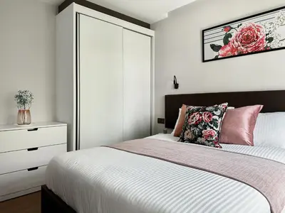 a bedroom with a bed and a dresser at Title V Poolside Pool View Gym Hammam in Rawai Beach
