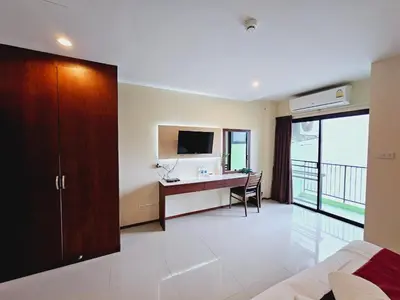 a hotel room with a desk and a computer in it at STAYHERE@AIRPORT SERVICE APARTMENT in Ban Bo Han