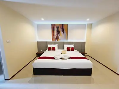 a bedroom with a large bed in a room at STAYHERE@AIRPORT SERVICE APARTMENT in Ban Bo Han