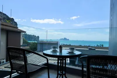 a table and chairs on a balcony with a view of the ocean at A401-Silk Condo Aonang, Sea view - 5 mins to beach in Krabi town