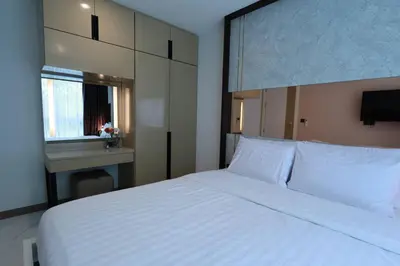 a bedroom with a large white bed and a window at A401-Silk Condo Aonang, Sea view - 5 mins to beach in Krabi town