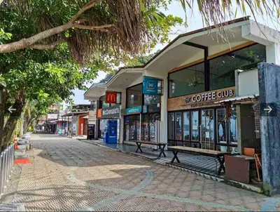 a street with a coffee shop on the side of the road at A401-Silk Condo Aonang, Sea view - 5 mins to beach in Krabi town