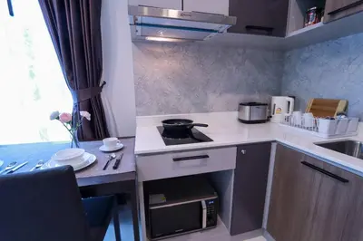 a small kitchen with a stove and a sink at A401-Silk Condo Aonang, Sea view - 5 mins to beach in Krabi town