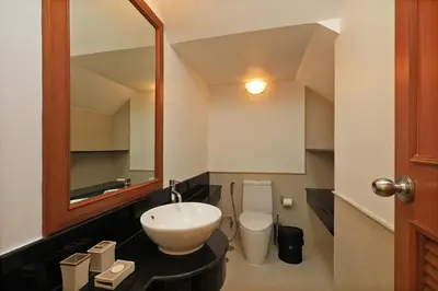 a bathroom with a sink and a toilet and a mirror at 2bdr Townhouse in Laguna Village by Capital Pro in Phuket Town