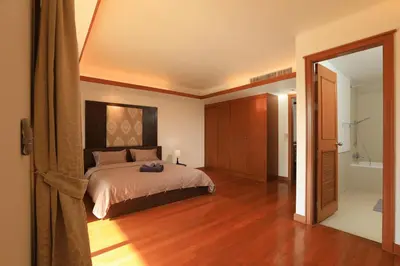 a bedroom with a bed and a bathroom with a tub at 2bdr Townhouse in Laguna Village by Capital Pro in Phuket Town