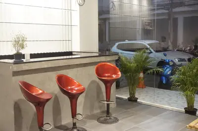 a group of red stools in front of a store at Blue Skyline Hotel in Patong Beach