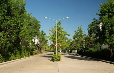 a street with a street sign on the side of a road at 2 bdr Townhouse in Laguna Park by CapitalPro in Phuket Town