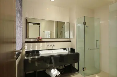 a bathroom with a sink and a glass shower at 3bdr Townhouse Laguna Park by CapitalPro 131 in Phuket Town