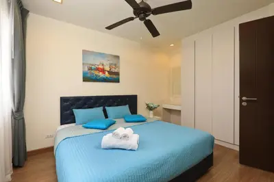 a bedroom with a blue bed with towels on it at 3bdr Townhouse Laguna Park by CapitalPro 131 in Phuket Town