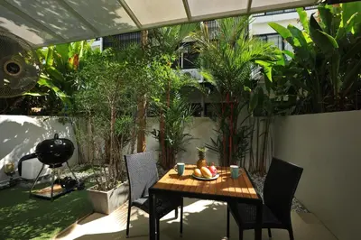 a patio with a table and chairs and plants at 3bdr Townhouse Laguna Park by CapitalPro 131 in Phuket Town