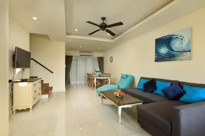a living room with a couch and a ceiling fan at 3bdr Townhouse Laguna Park by CapitalPro 131 in Phuket Town