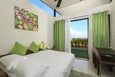 a bedroom with a bed and a large window at 3bdr Townhouse Laguna Park Bangtao Beach by CapitalPro in Phuket Town