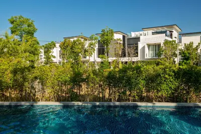 a swimming pool in front of a building at 3bdr Townhouse Laguna Park Bangtao Beach by CapitalPro in Phuket Town