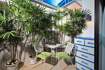 a room with a table and chairs and potted plants at 3bdr Townhouse Laguna Park Bangtao Beach by CapitalPro in Phuket Town