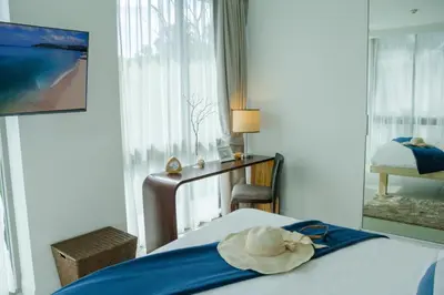 a hotel room with a bed with a towel on it at 2bdr Apartment Oceanstone Laguna by Capital Pro in Phuket Town