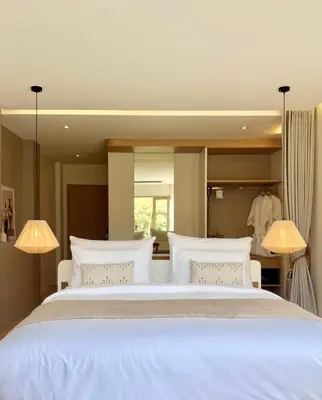 a bedroom with a large white bed with two lamps at Ton Sai Tropical Phi Phi Island in Phi Phi Don