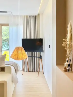 a bedroom with a bed and a television and a lamp at Ton Sai Tropical Phi Phi Island in Phi Phi Don