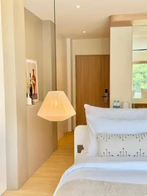 a bedroom with a white bed and a lamp at Ton Sai Tropical Phi Phi Island in Phi Phi Don