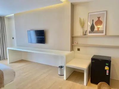 a room with a desk with a tv on the wall at Ton Sai Tropical Phi Phi Island in Phi Phi Don
