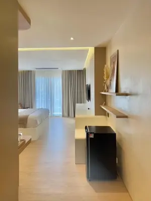 a hotel room with a bed and a desk at Ton Sai Tropical Phi Phi Island in Phi Phi Don