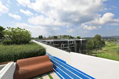 a balcony with a bench on top of a building at Bangtao beach Cozy apartments by Capitalpro in Phuket Town