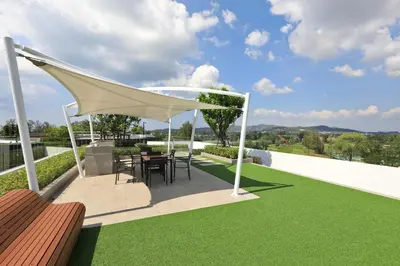 a gazebo with a table and chairs on a patio at Bangtao beach Cozy apartments by Capitalpro in Phuket Town
