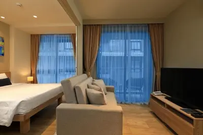 a bedroom with a bed and a flat screen tv at 1bdr Cozy apartment in Diamond Resort Bangtao Beach by Capital Pro in Phuket Town