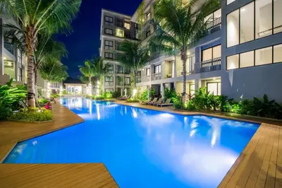 a swimming pool in the middle of a building at night at 1bdr Cozy apartment in Diamond Resort Bangtao Beach by Capital Pro in Phuket Town