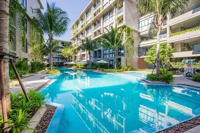 a swimming pool in front of a building at 1bdr Cozy apartment in Diamond Resort Bangtao Beach by Capital Pro in Phuket Town