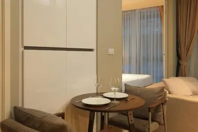 a living room with a table with two wine glasses at 1bdr Cozy apartment in Diamond Resort Bangtao Beach by Capital Pro in Phuket Town