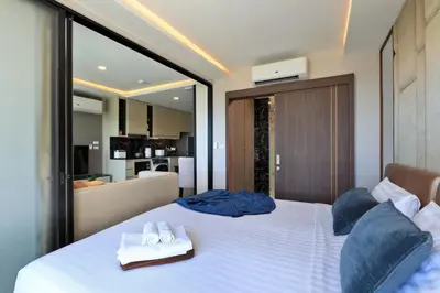 a bedroom with a bed with two towels on it at 1 bdr Sea view Apartment in Mida Surin Beach by Capital Pro in Phuket Town