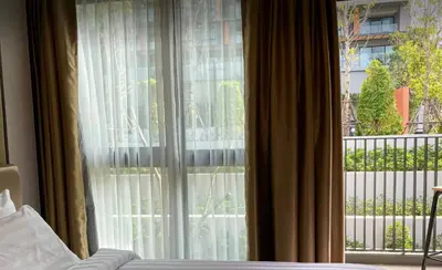 a bedroom window with a view of a balcony at 2 bdr Apartment in Mida Grande Surin Beach by CapitalPro in Phuket Town