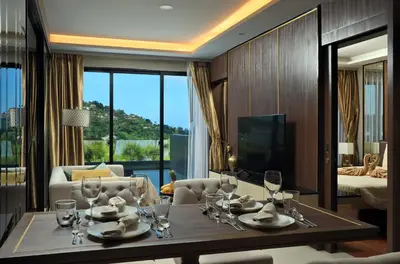 a dining room with a table and a living room at 2bdr Apartment with Jacuzzi SeaView by CapitalPro 307 in Phuket Town