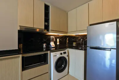 a kitchen with a refrigerator and a dishwasher at 2bdr Apartment with Jacuzzi SeaView by CapitalPro 307 in Phuket Town