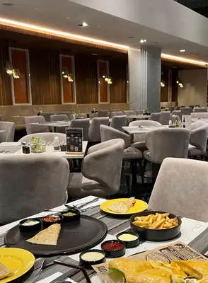 a dining room with tables and chairs with food on them at 2bdr Apartment with Jacuzzi SeaView by CapitalPro 307 in Phuket Town