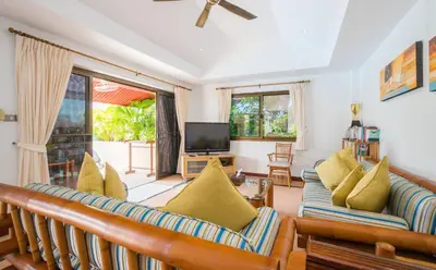a living room with two couches and a television at Villa Malee , Sea View Infinity Pool, Staff, Chef in Kata Beach