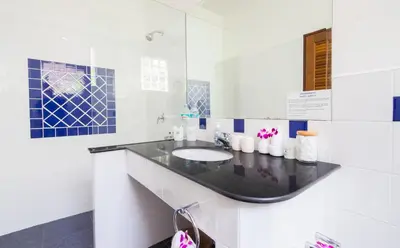 a bathroom with a sink and a mirror at Villa Malee , Sea View Infinity Pool, Staff, Chef in Kata Beach