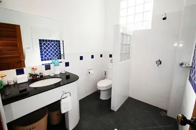 a white bathroom with a sink and a toilet at Villa Malee , Sea View Infinity Pool, Staff, Chef in Kata Beach