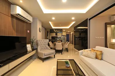 a living room with a couch and a table at 3 bdr SeaView Apartment walking to Surin Beach by CapitalPro in Phuket Town