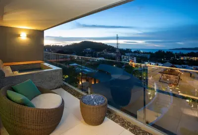 a balcony with a view of a city at night at 3 bdr SeaView Apartment walking to Surin Beach by CapitalPro in Phuket Town