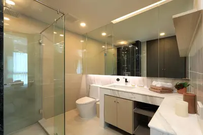 a bathroom with a toilet and a glass shower at Mountain view Apartment Surin Beach 716 by CapitalPro in Phuket Town