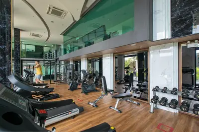 a gym with a bunch of exercise equipment in a building at Mountain view Apartment Surin Beach 716 by CapitalPro in Phuket Town