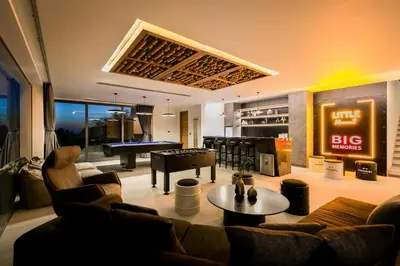 a living room with a couch and a pool table at Villa Nordic Star Seaview Near Kata Beach in Kata Beach