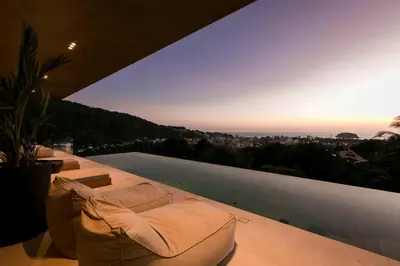 a living room with a couch and a view of the city at Villa Nordic Star Seaview Near Kata Beach in Kata Beach