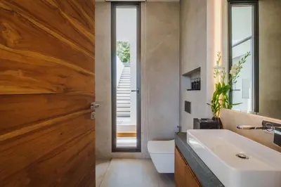 a bathroom with a white sink and a wooden door at Villa Nordic Star Seaview Near Kata Beach in Kata Beach