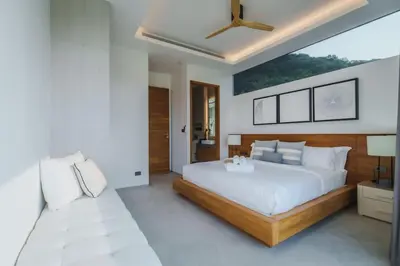 a bedroom with a large bed and a ceiling fan at Villa Nordic Star Seaview Near Kata Beach in Kata Beach